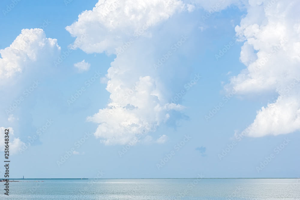 Serene seascape with white fluffy clouds above the sea