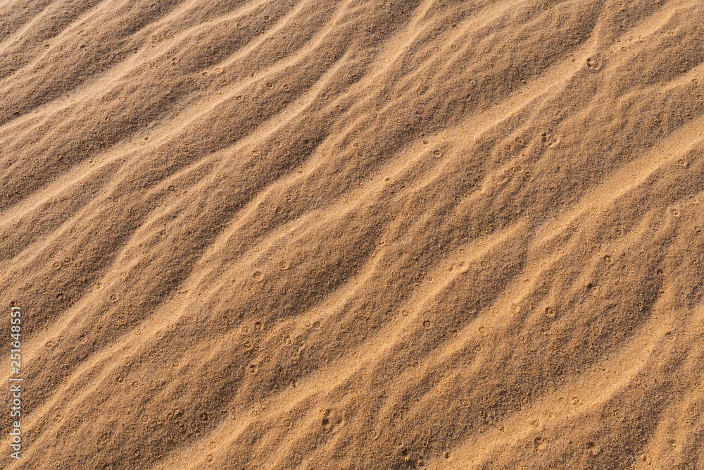 Amazing abstract background image of ripples and waves in the sand at sunrise Amazing abstract background image of ripples and waves in the sand at sunrise