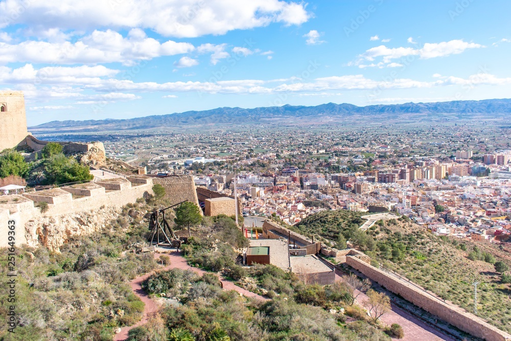 The view from another tower of Lorca Castle in southern Spain, shows the great tower and surrounding walls of the keep, with a trebuchet replica standing ready to attack. 