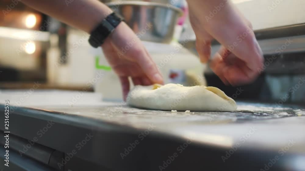 Male working with dough close up. Chef preparing khachapuri Georgian cheese pie with egg. Tasty dish making in cafe. Georgian cuisine Male working with dough close up. Chef preparing khachapuri Georgian cheese pie with egg. Tasty dish making in cafe. Georgian cuisine