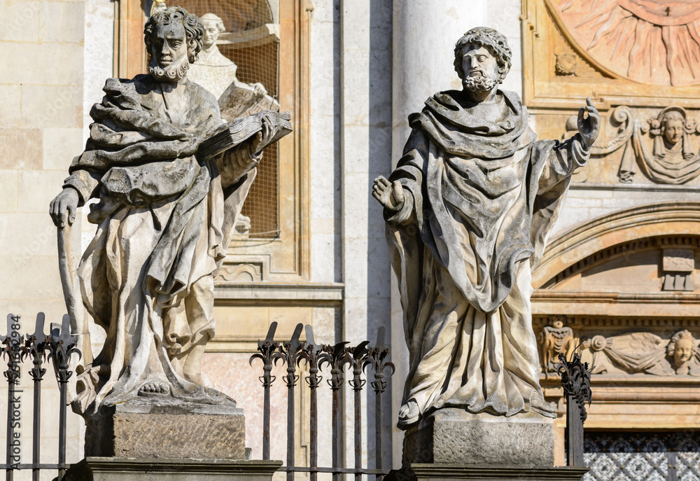 Naklejka premium Krakow. In the lower part of the facade of the Cathedral of Saints Peter and Paul there are 4 statues of the most famous Jesuits, above the entrance there is an emblem of the Jesuit Order.