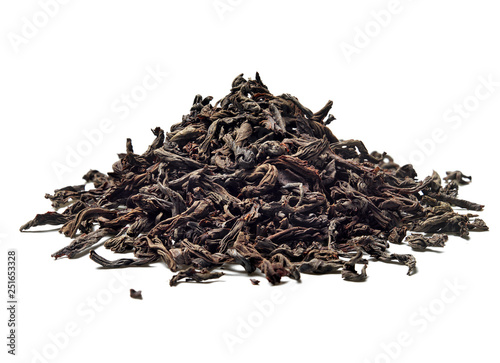 Heap of black leaf tea on white background. Close up. High resolution.