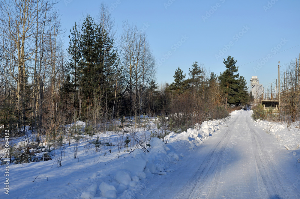 Sunny winter frosty day. Winter road to the railway platform. Sunny winter frosty day. Winter road to the railway platform.