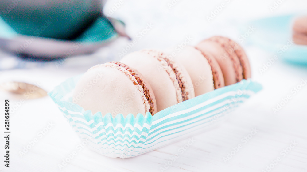 French dessert chocolate and vanilla macaroons on a white background. 16:9