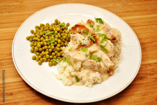 Pork with Cream Sauce Over White Rice & a Side Dish of Peas