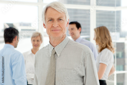 corporate business leader with team in office - portrait