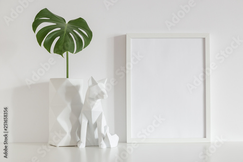 White frame mock up, origami vase decoration and monstera. photo