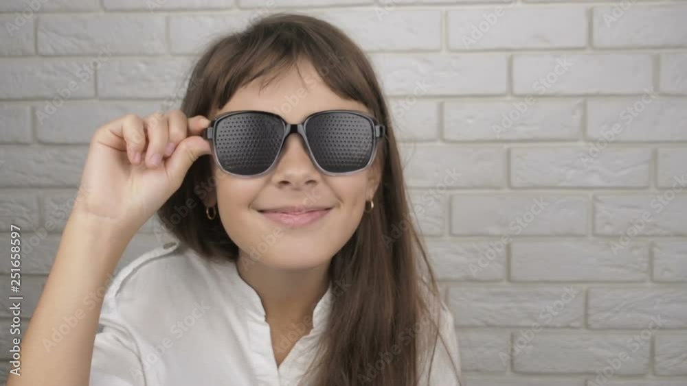 A child with poor eyesight wears training glasses. Cute girl in obscura glasses. A child with poor eyesight wears training glasses. Cute girl in obscura glasses.