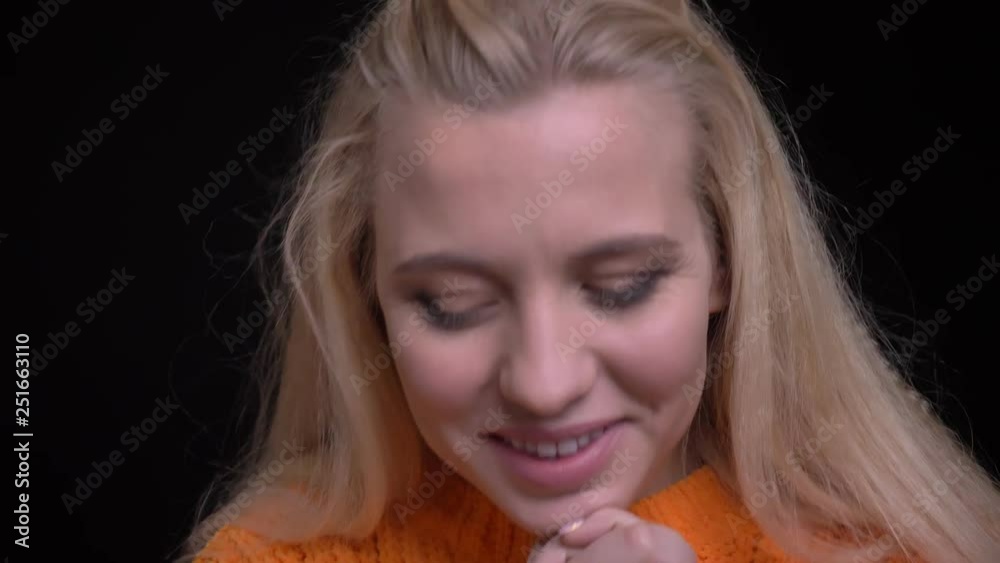 Closeup shoot of young pretty caucasian girl with long blonde hair being excited and smiling while looking at camera Closeup shoot of young pretty caucasian girl with long blonde hair being excited and smiling while looking at camera