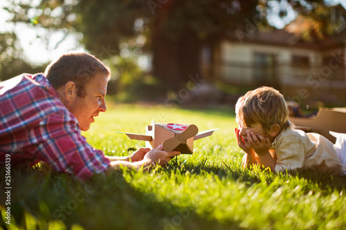 Home made cardboard plane in a sunny back yard.