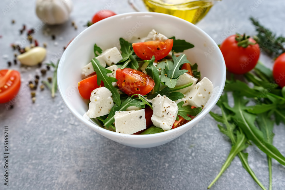 Italian cuisine. Vegetarian food. Salad with mozzarella, arugula and cherry tomatoes.