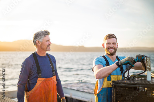 Father and son operating fishing business. photo