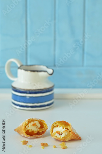 Chiacchiere - Italian cookie stuffed with ricotta on a light background photo