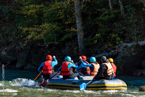 Group of tourists go rafting in river back view © Yakov