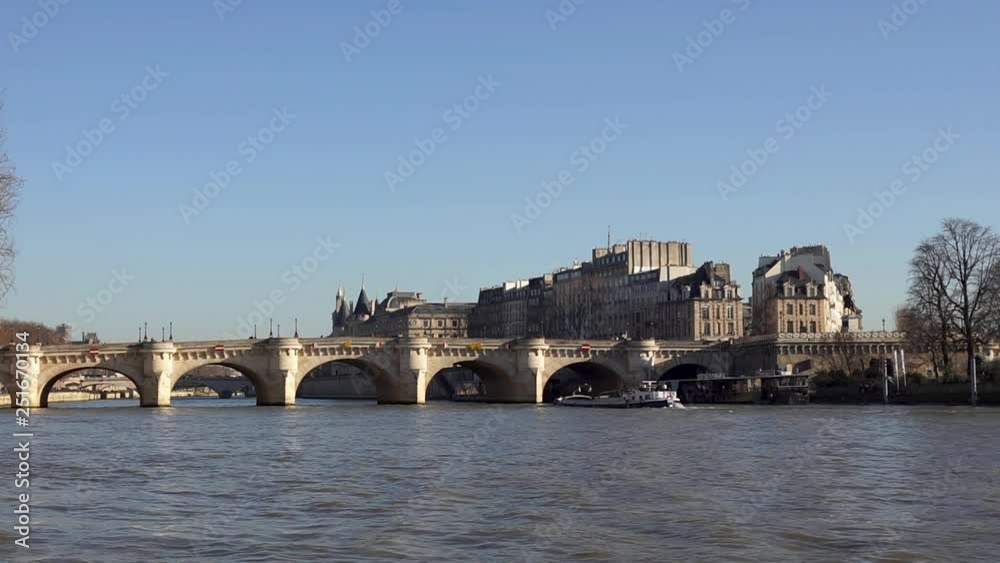 Boat traffic under Pont Neuf (new Bridge) on the Seine River - Paris, France