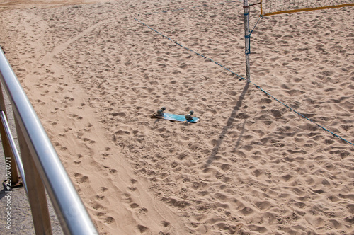 skateboard lies turned upside down on a sandy beach