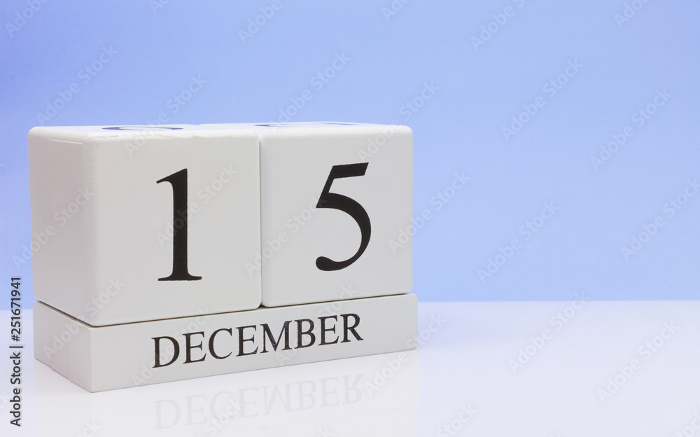 December 15st. Day 15 of month, daily calendar on white table with reflection, with light blue background. Winter time, empty space for text December 15st. Day 15 of month, daily calendar on white table with reflection, with light blue background. Winter time, empty space for text