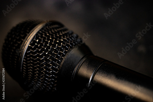 Black microphone close up with a smoke background