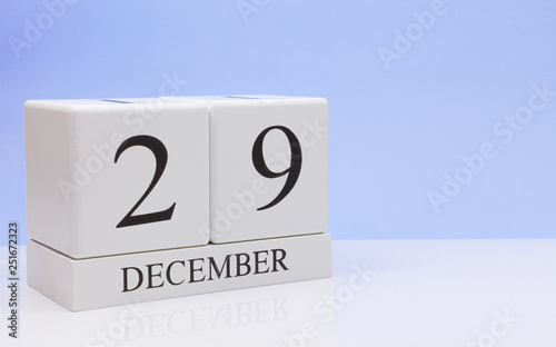 December 29st. Day 29 of month, daily calendar on white table with reflection, with light blue background. Winter time, empty space for text photo