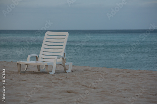 A White Beach Chair on the Beautiful Sunset Beach. Ahtlantic Ocean on a Background © Marina Tolkacheva