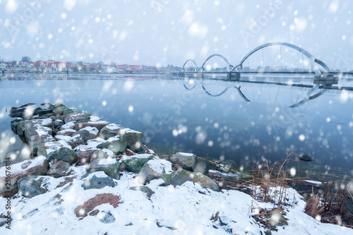 Solvesborgsbron pedestrian bridge with falling snow in the south of Sweden photo