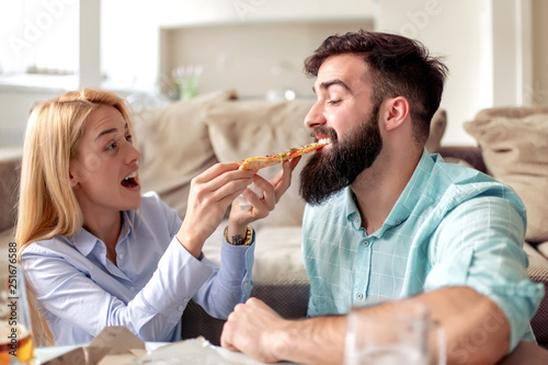 Couple eating pizza at home,enjoying together