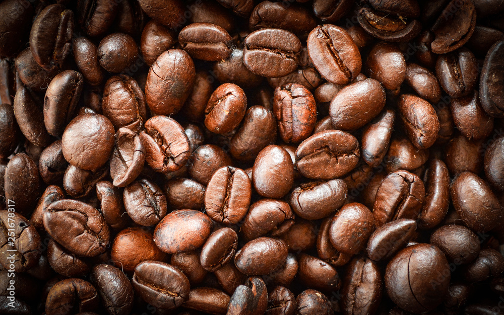 Obraz premium Close up of Coffee beans roasted texture background - top view
