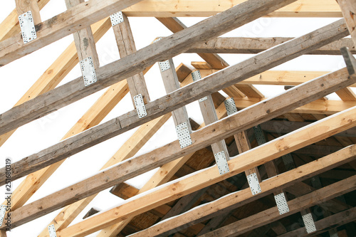 Construction of the wooden frame of a roof. Iinstalling trusses. DIY. Ecological building. Lumber and material.