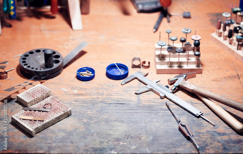 vintage jeweler tools and diamonds over  working bench, blank business card for your text