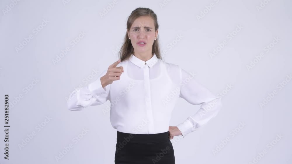 Young angry pregnant businesswoman talking and pointing at camera Young angry pregnant businesswoman talking and pointing at camera