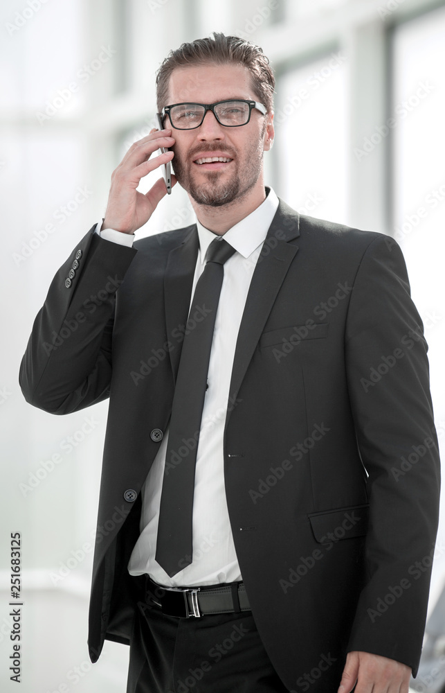 smiling businessman talking on mobile phone smiling businessman talking on mobile phone