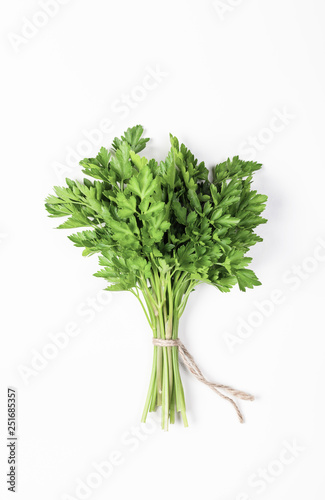 Parsley bunch isolated on white background. Flat lay. Top view. Minimal food concept.