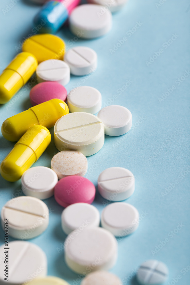 Assorted pharmaceutical medicine pills, tablets and capsules. Blue background. Assorted pharmaceutical medicine pills, tablets and capsules. Blue background.
