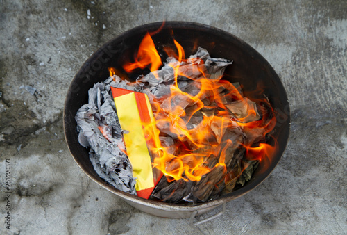 Fire burning gold paper fake respect to pay predecessor in Chinese New Year festival.