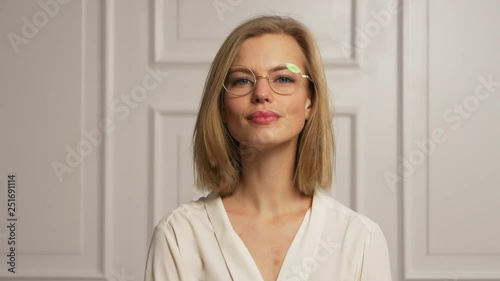 Model wearing white blouse and glasses