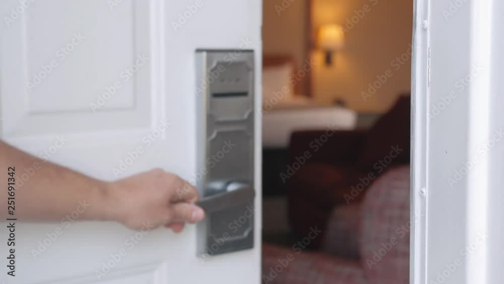 Man Opens Hotel Door With Card Focuses On Bed. Close up shot showing a man's hand pulling the door handle and closing the door. Man Opens Hotel Door With Card Focuses On Bed. Close up shot showing a man's hand pulling the door handle and closing the door.