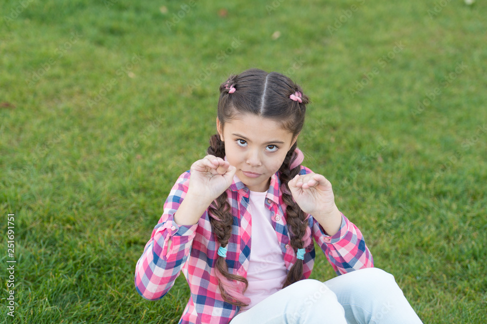 Springtime concept. Park and garden. Kid gadabout. Girl little kid spend leisure outdoors in park. Girl sit on grass in park. Child enjoy spring sunny weather while sitting at meadow in park Springtime concept. Park and garden. Kid gadabout. Girl little kid spend leisure outdoors in park. Girl sit on grass in park. Child enjoy spring sunny weather while sitting at meadow in park