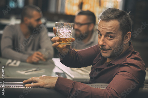 Fotografie Client of bar looking back through shoulder at camera