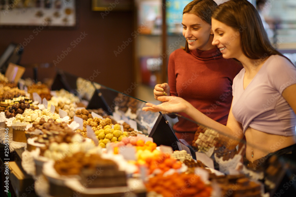 Showcase with large assortment of handmade candies and sweets in specialized store.