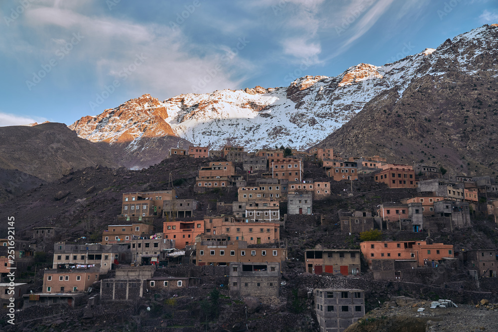 A view of sunset in rural mountain village Imlil in High Atlas mountains Morocco Africa with snow covered peaks in background