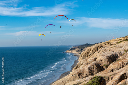 Paragliding over the cliffs and beach photo