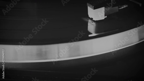 Vinyl record spinning on the turntable in black and white