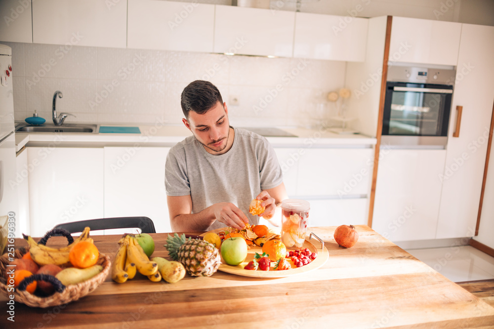 Young caucasian man preparing his healthy smoothie in the morning. Young caucasian man preparing his healthy smoothie in the morning.