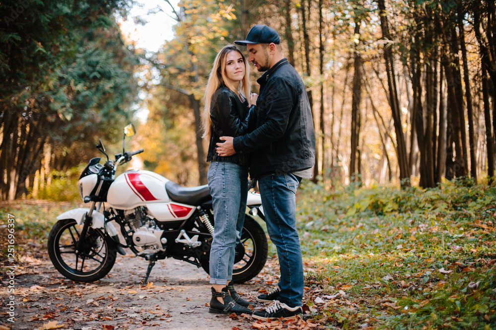 young couple on motorcycle laugh