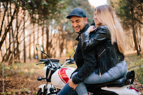 young couple on motorcycle laugh