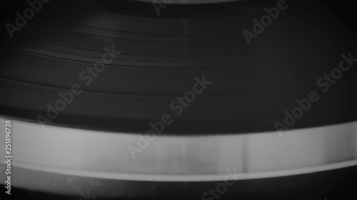 Vinyl record spinning on the turntable in black and white