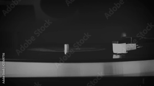 Vinyl record spinning on the turntable in black and white