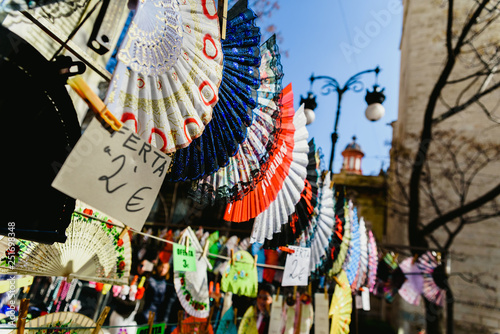 Valencia, Spain - February 24, 2019: Typical colorful Spanish flamenco fans for sale in a street market in spring. photo