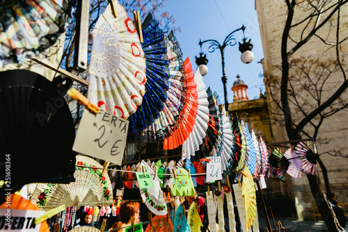 Valencia, Spain - February 24, 2019: Typical colorful Spanish flamenco fans for sale in a street market in spring. photo