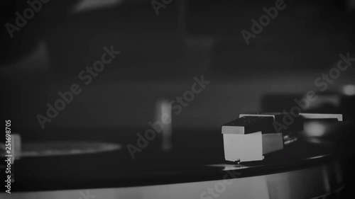 Vinyl record spinning on the turntable in black and white